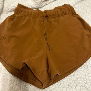 Size 2 lululemon inner glow high rise shorts 3”. In a copper brown color